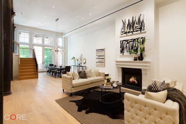 living room with a notable chandelier and light hardwood / wood-style flooring