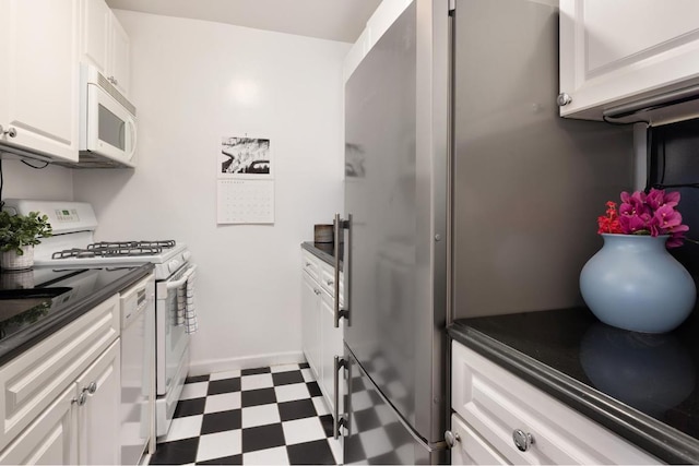 kitchen with white cabinetry and white appliances