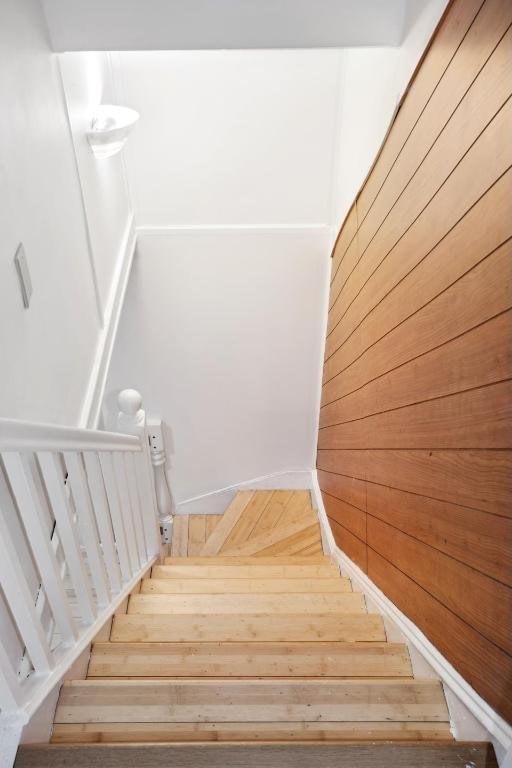 stairway with wooden walls