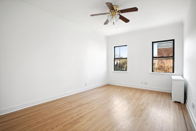 unfurnished room featuring ceiling fan and light hardwood / wood-style flooring