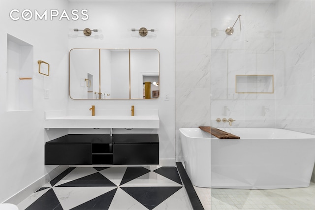 bathroom featuring a freestanding bath, baseboards, double vanity, and a shower