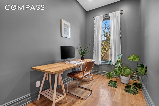 home office featuring baseboards and wood finished floors