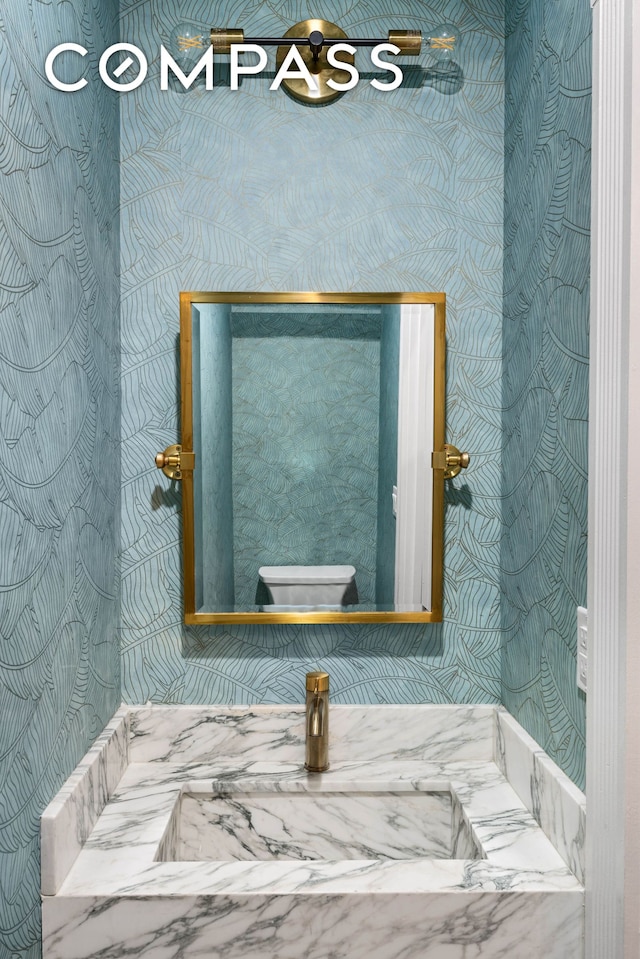 bathroom view of wallpapered walls and toilet