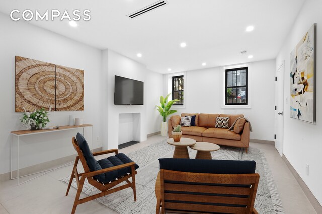 living room with recessed lighting and baseboards