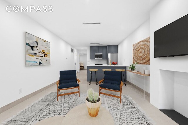 kitchen featuring light parquet flooring, pendant lighting, backsplash, and a center island