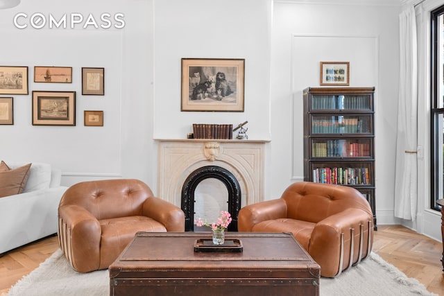 living area featuring a fireplace and baseboards