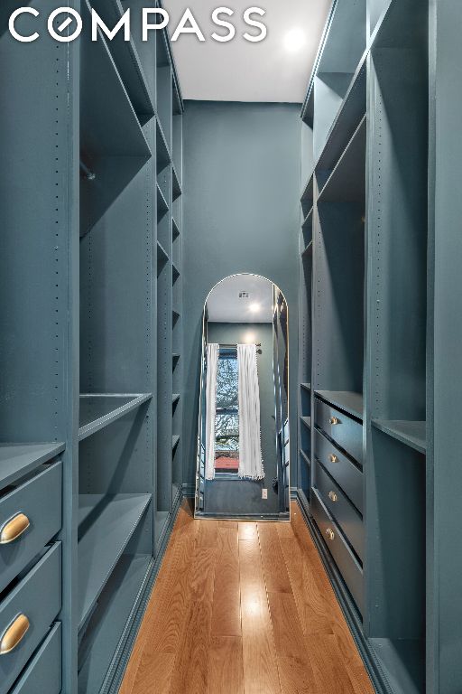 spacious closet featuring hardwood / wood-style floors