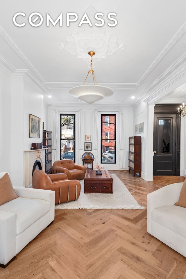 living room featuring ornamental molding, coffered ceiling, and decorative columns