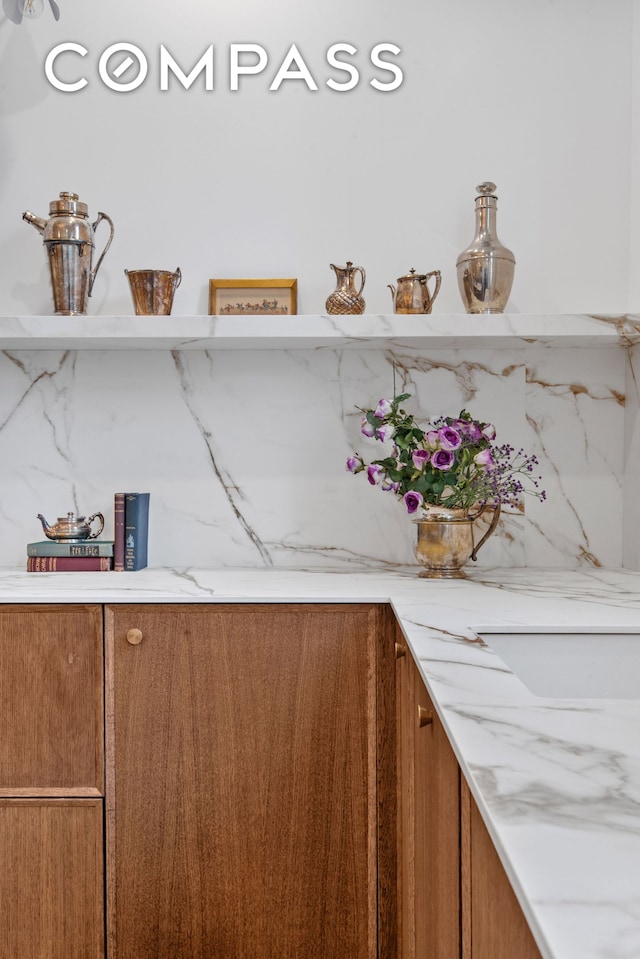 detailed view of brown cabinetry and backsplash
