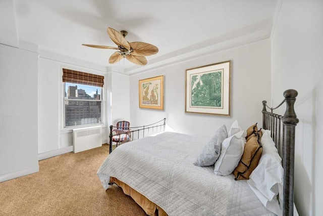 carpeted bedroom featuring ceiling fan and radiator heating unit