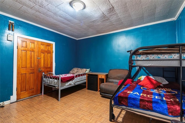 bedroom with light parquet floors and crown molding