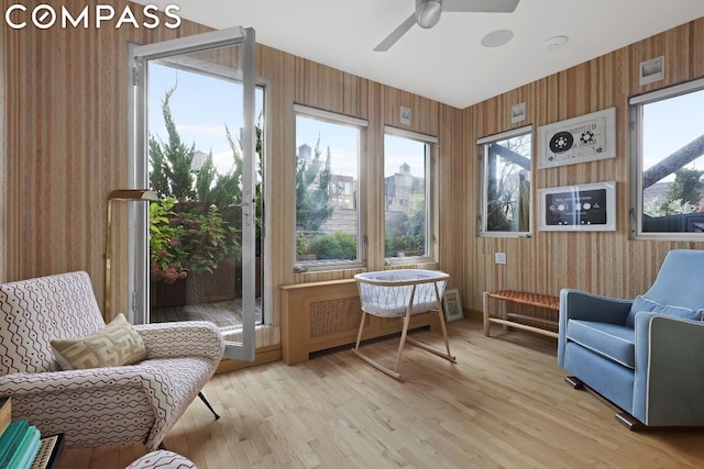 sunroom / solarium featuring ceiling fan