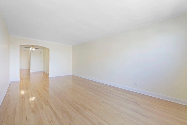 empty room featuring light hardwood / wood-style flooring and crown molding