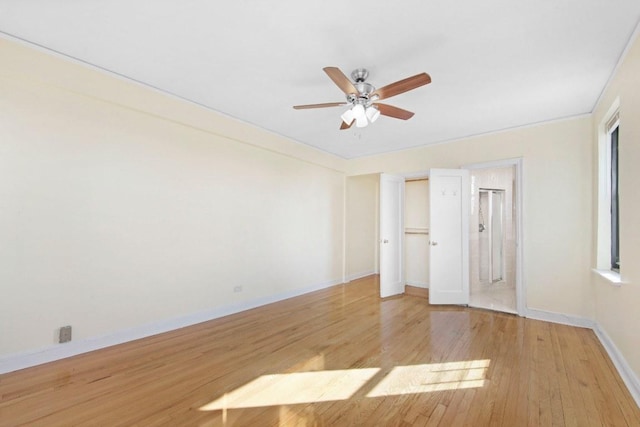 unfurnished bedroom featuring ceiling fan, ensuite bath, light wood-type flooring, and baseboards