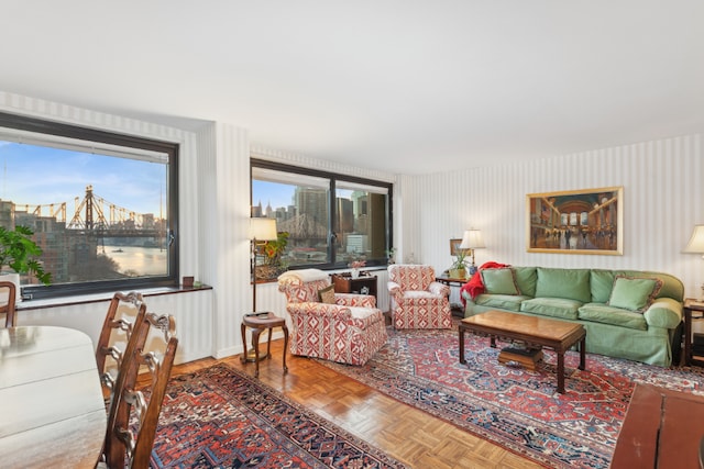 living room with a water view and parquet flooring