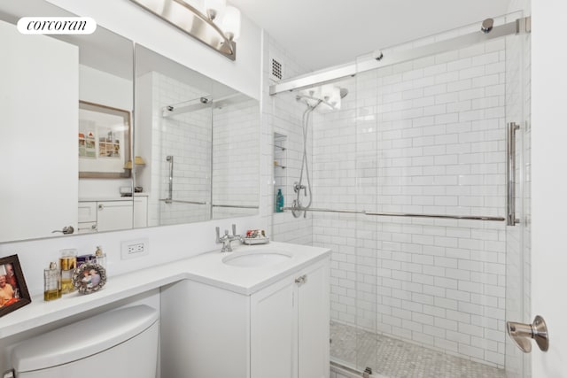 bathroom featuring a stall shower, visible vents, vanity, and toilet