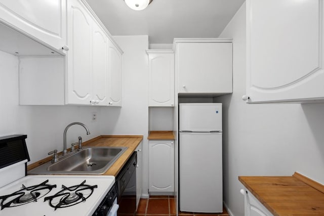 kitchen featuring sink, white appliances, white cabinets, and butcher block counters