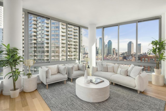 living room with expansive windows and hardwood / wood-style flooring