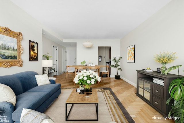 living area featuring baseboards