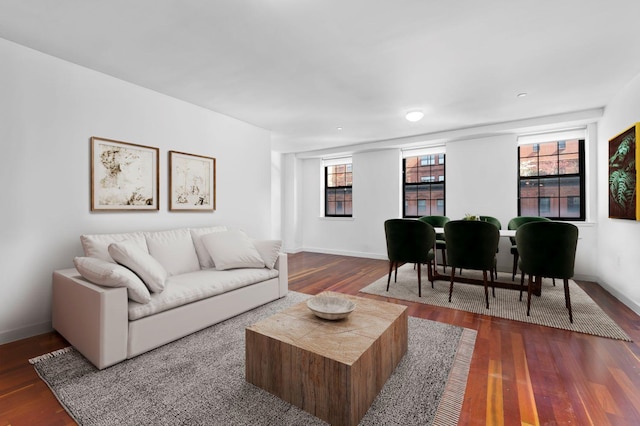 living room featuring baseboards and dark wood finished floors