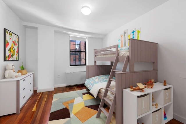 bedroom with baseboards and wood finished floors