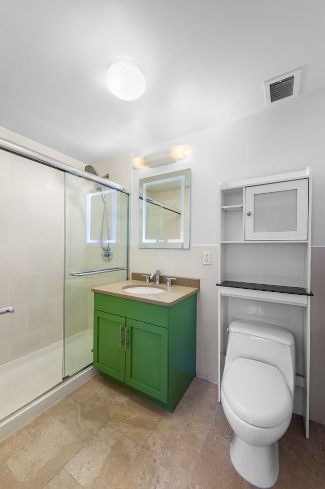 full bath featuring tile walls, visible vents, toilet, a stall shower, and vanity