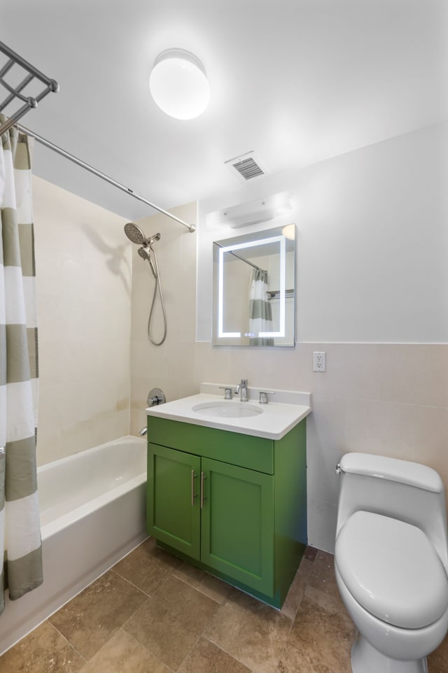 full bath with tile walls, visible vents, shower / bathtub combination with curtain, toilet, and vanity