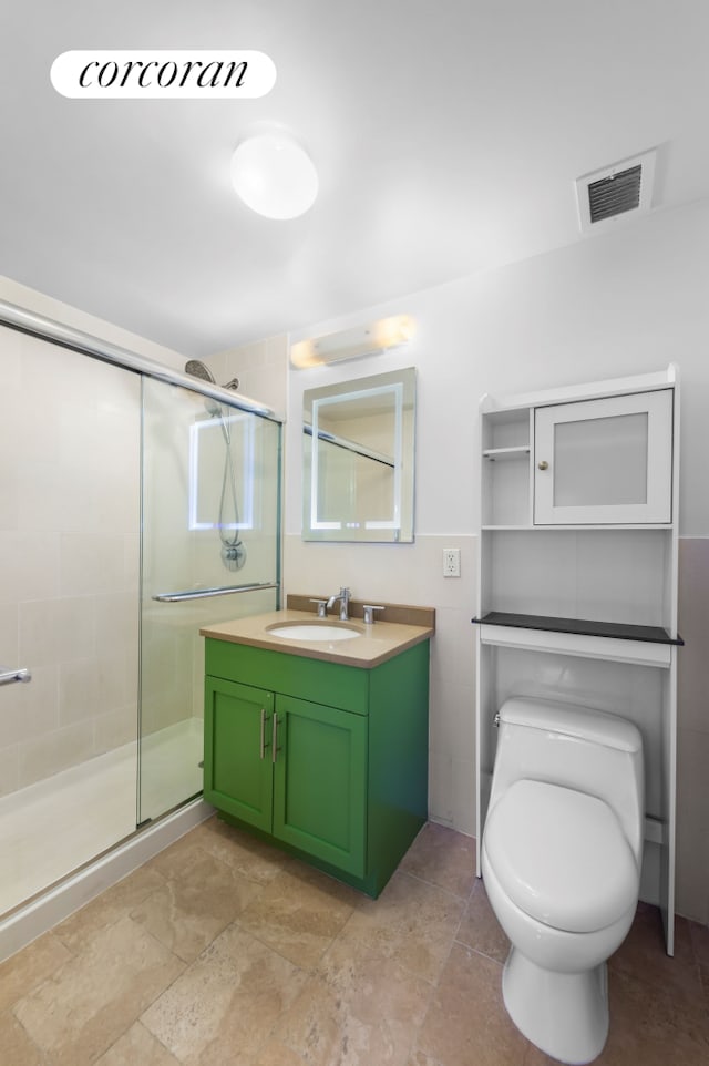 full bathroom featuring a stall shower, visible vents, vanity, and toilet