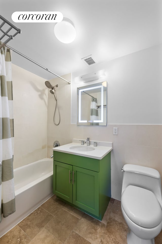 full bath featuring toilet, visible vents, vanity, tile walls, and shower / bathtub combination with curtain