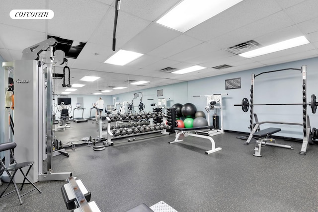 gym featuring visible vents and a drop ceiling