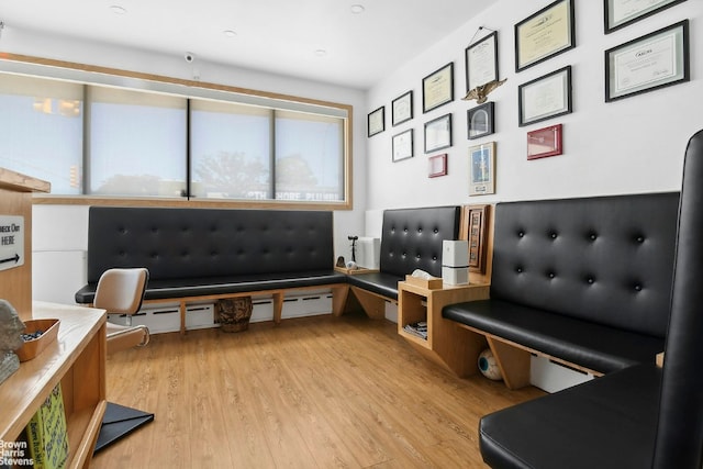 sitting room featuring baseboard heating and light hardwood / wood-style floors