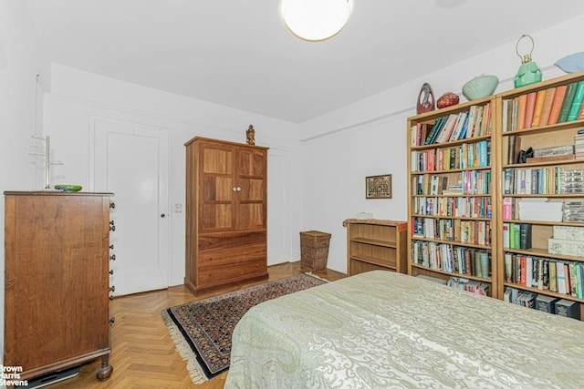 bedroom featuring parquet flooring