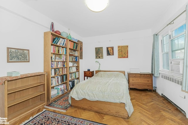 bedroom featuring cooling unit and parquet flooring