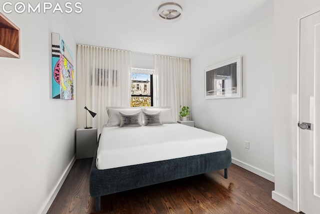 bedroom with dark hardwood / wood-style flooring