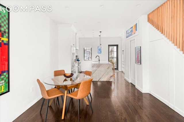 dining area with sink and dark hardwood / wood-style floors