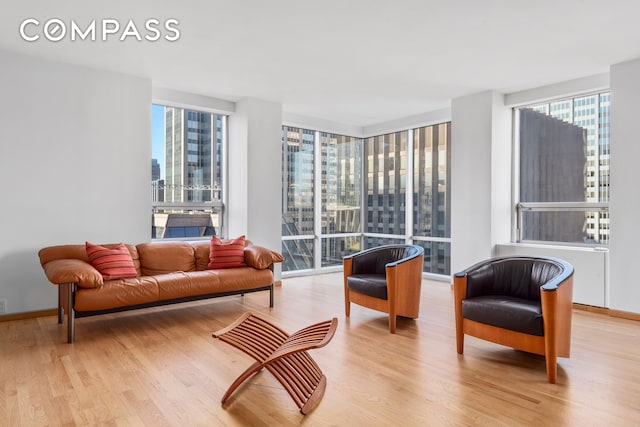 living area with a city view and wood finished floors