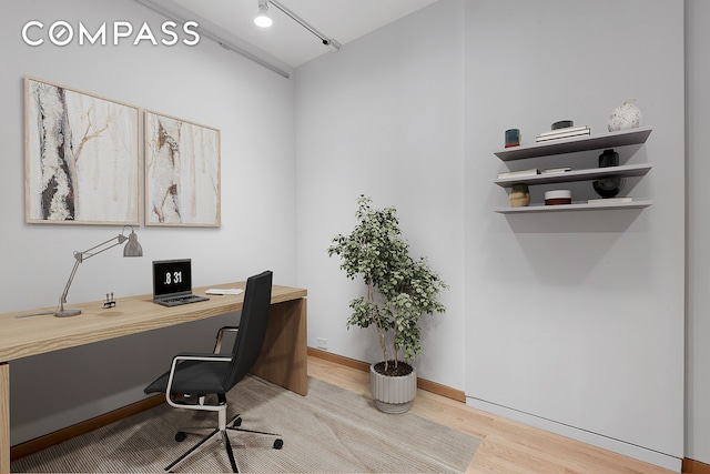 office area featuring wood finished floors and baseboards