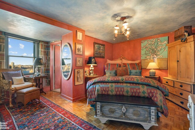 bedroom featuring light parquet flooring and a chandelier