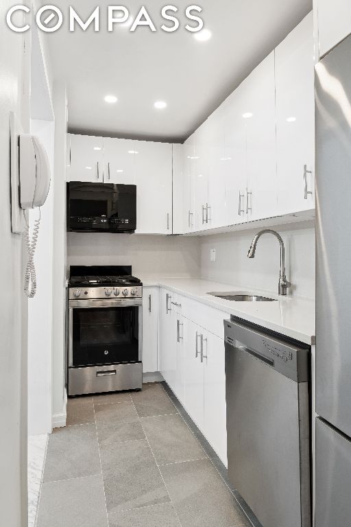 kitchen with sink, white cabinetry, and stainless steel appliances