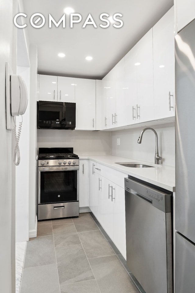45 Sutton Pl S Unit 15G, New York City, NY 10022 - kitchen with stainless steel appliances, light countertops, white cabinets, and modern cabinets