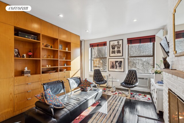 living room featuring dark wood-type flooring and a fireplace