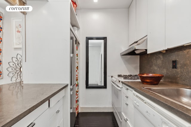 kitchen featuring backsplash, dark wood-type flooring, white appliances, and white cabinetry