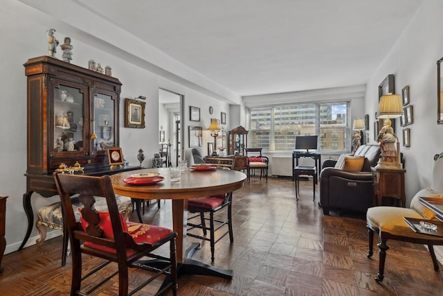 dining area featuring parquet floors