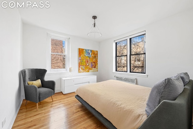 bedroom featuring light hardwood / wood-style floors and radiator