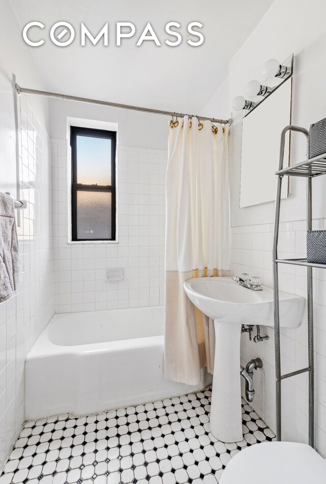 bathroom with toilet, tile patterned flooring, and shower / bath combination with curtain