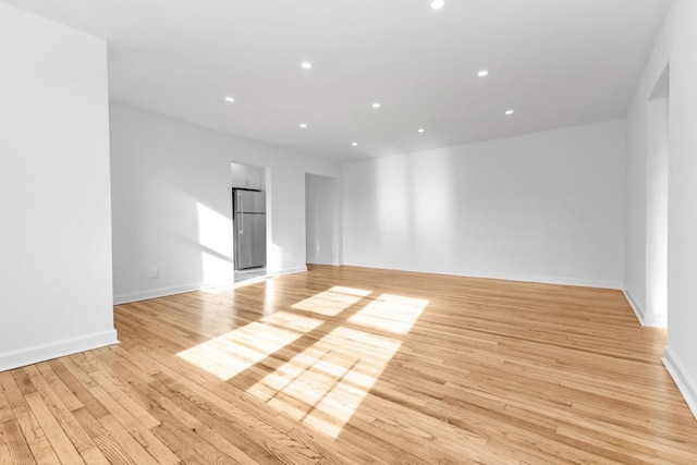 spare room featuring light wood-type flooring