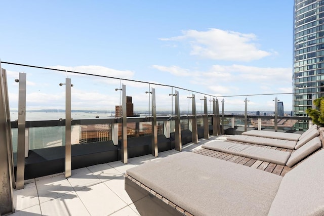 view of patio / terrace featuring a water view and a balcony