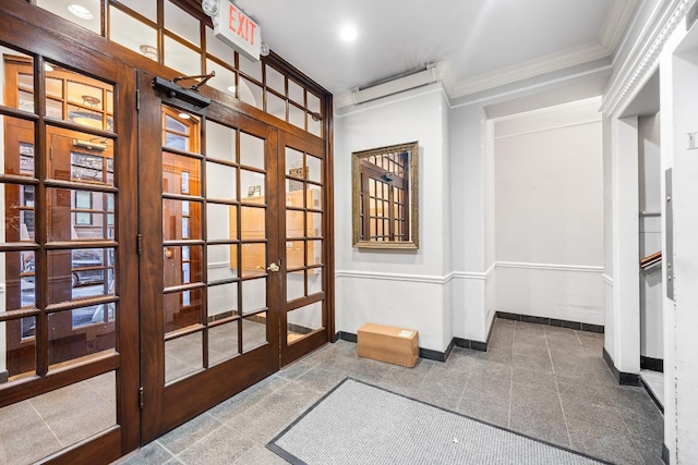 doorway to outside with ornamental molding and french doors