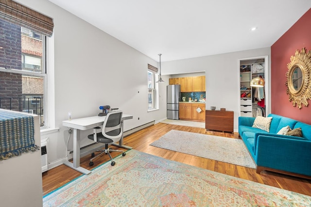 office area featuring a baseboard radiator and light wood-type flooring