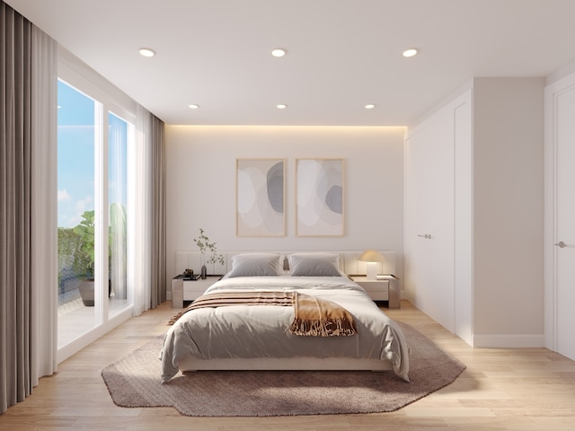 bedroom featuring light wood-type flooring and access to outside